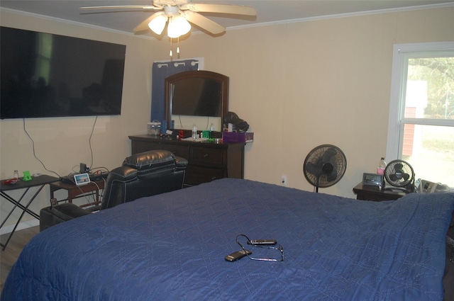 bedroom with ornamental molding and ceiling fan