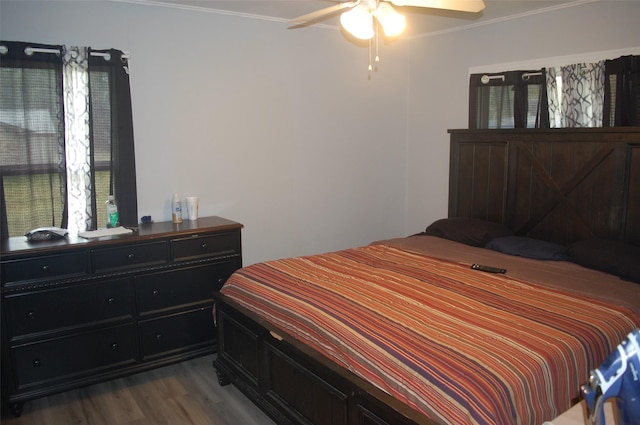 bedroom featuring hardwood / wood-style flooring, ceiling fan, and ornamental molding