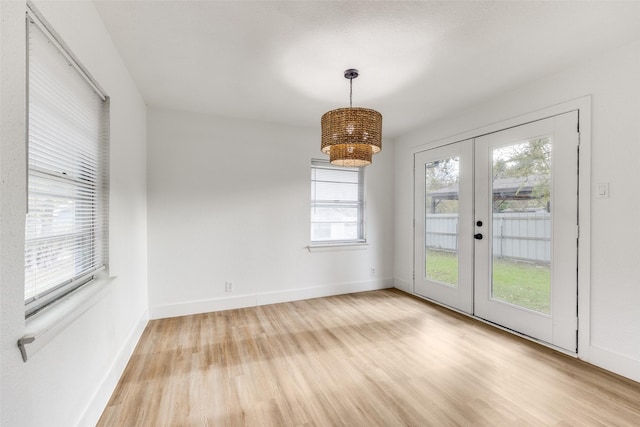 spare room with light hardwood / wood-style flooring and french doors