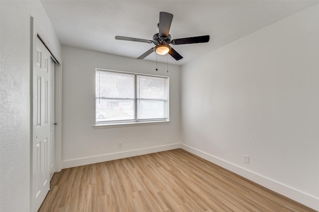 unfurnished bedroom with a closet, light hardwood / wood-style flooring, and ceiling fan