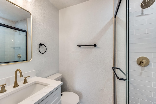 bathroom with vanity, toilet, and walk in shower