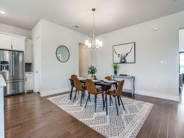 dining room featuring a notable chandelier and dark hardwood / wood-style floors