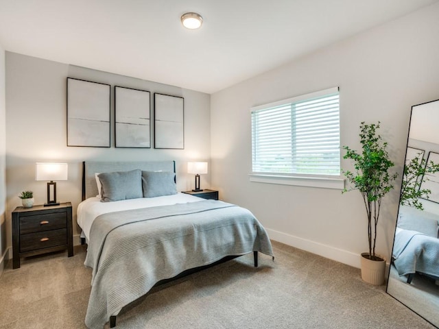 bedroom featuring light carpet