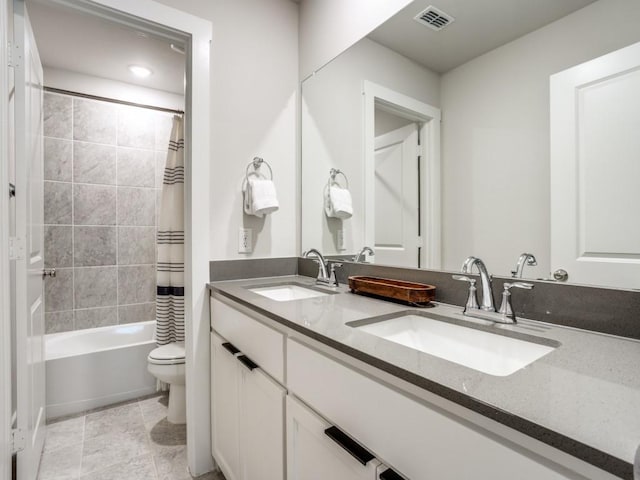 full bathroom featuring tile patterned flooring, shower / tub combo with curtain, vanity, and toilet