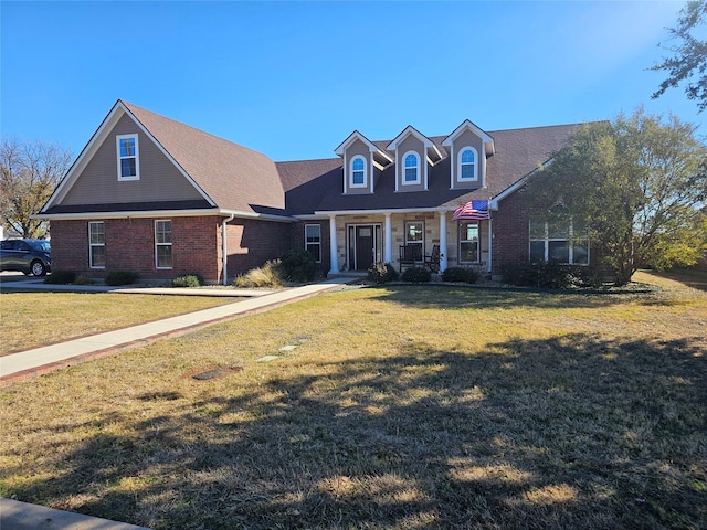 view of front facade featuring a front lawn and covered porch