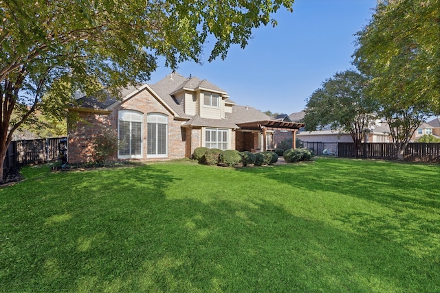 rear view of property featuring a pergola and a yard