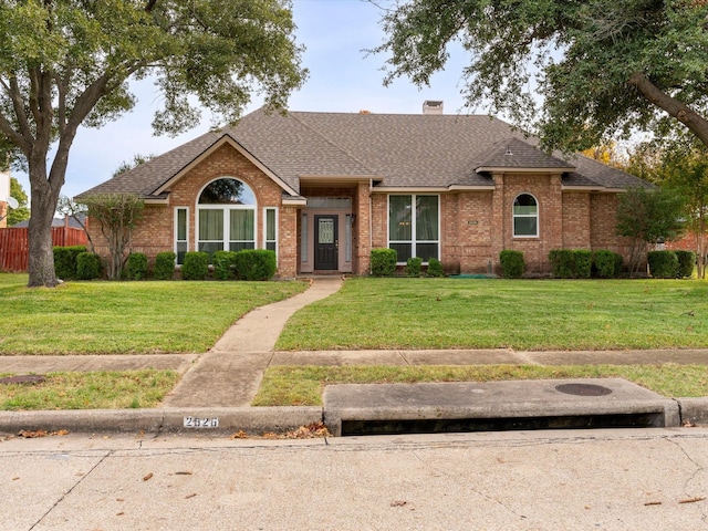 single story home featuring a front yard