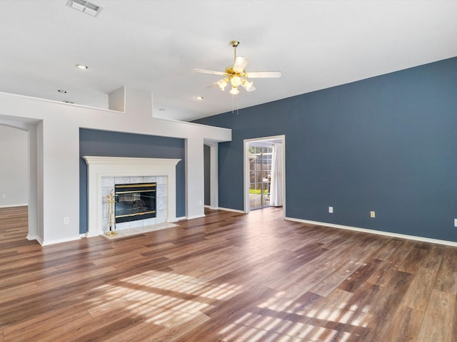 unfurnished living room with a fireplace, ceiling fan, and dark hardwood / wood-style flooring