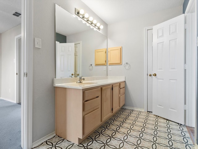 bathroom with a textured ceiling and vanity