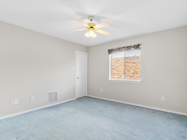 carpeted empty room featuring ceiling fan