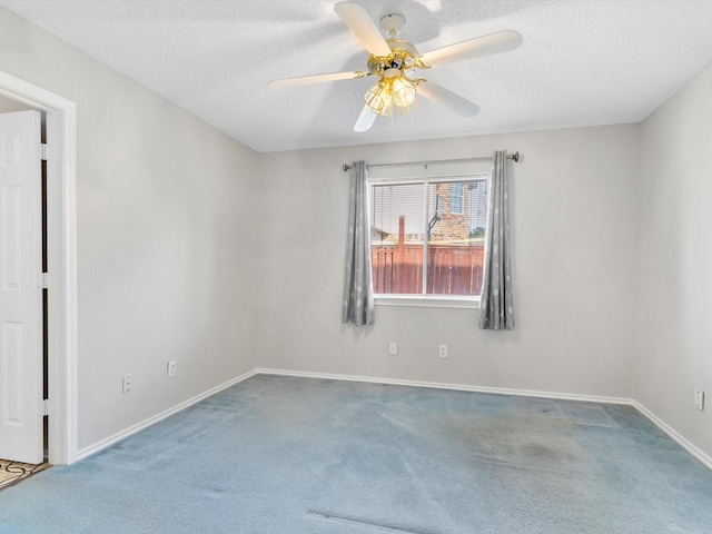 unfurnished room with carpet flooring, ceiling fan, and a textured ceiling