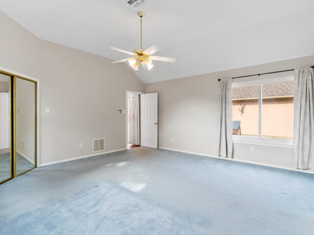 spare room with carpet, ceiling fan, and high vaulted ceiling