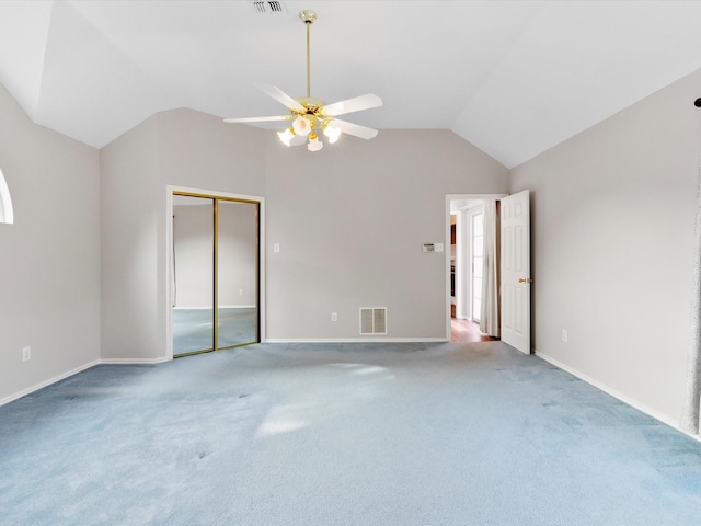 carpeted empty room with ceiling fan and lofted ceiling