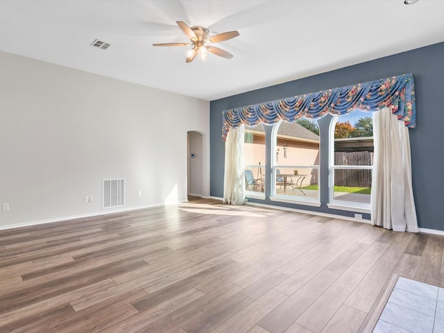 spare room with ceiling fan and hardwood / wood-style flooring