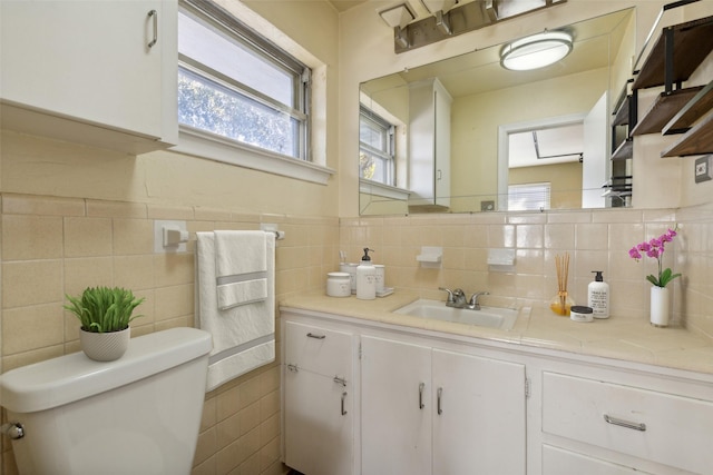 bathroom featuring decorative backsplash, vanity, and toilet