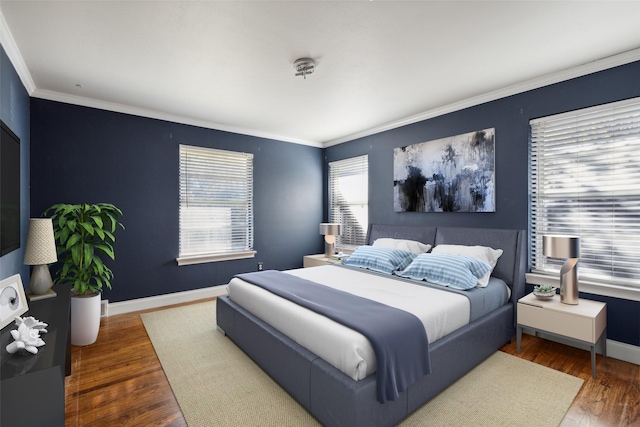 bedroom featuring dark hardwood / wood-style flooring and ornamental molding