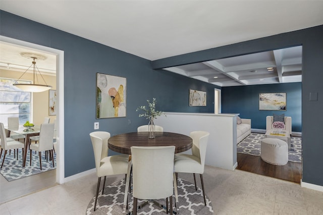 dining room with light hardwood / wood-style floors, beam ceiling, and coffered ceiling