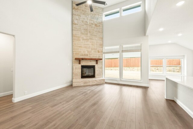 kitchen with stainless steel appliances, a kitchen island with sink, sink, light hardwood / wood-style flooring, and white cabinets