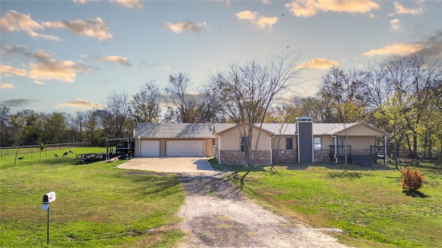 view of front of property featuring a garage and a front lawn