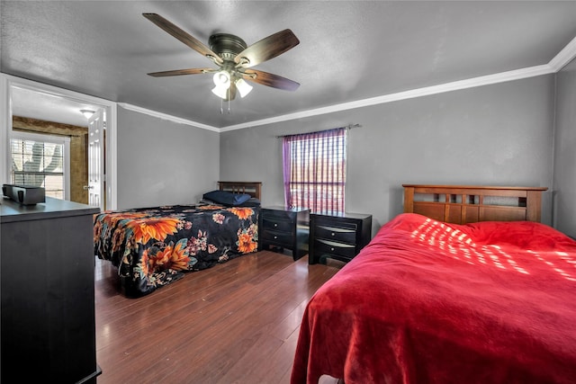 bedroom featuring a textured ceiling, crown molding, ceiling fan, and dark wood-type flooring