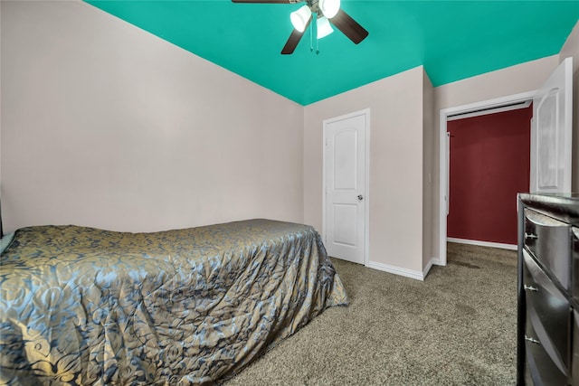 carpeted bedroom with ceiling fan, a closet, and lofted ceiling