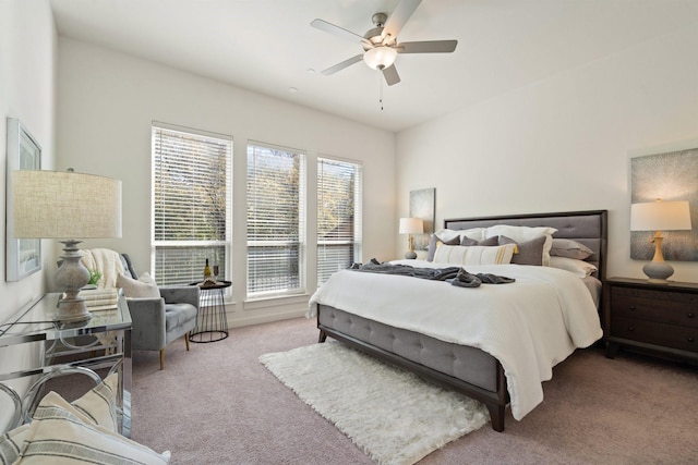 bedroom featuring ceiling fan and light carpet