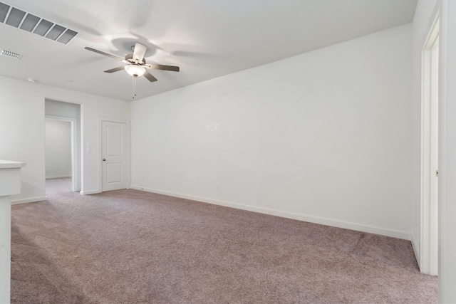 carpeted spare room featuring ceiling fan