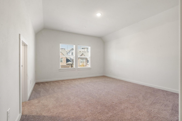 empty room featuring carpet flooring and lofted ceiling