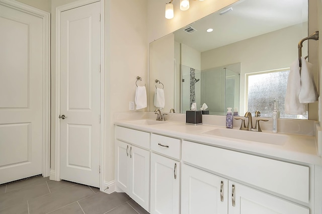 bathroom featuring tile patterned flooring, vanity, and an enclosed shower