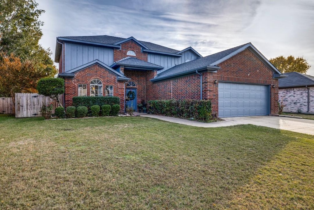 front facade with a front lawn and a garage