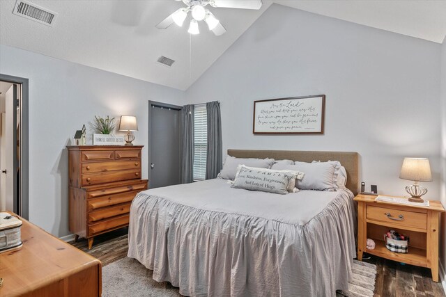 bedroom featuring ceiling fan, dark wood-type flooring, and high vaulted ceiling