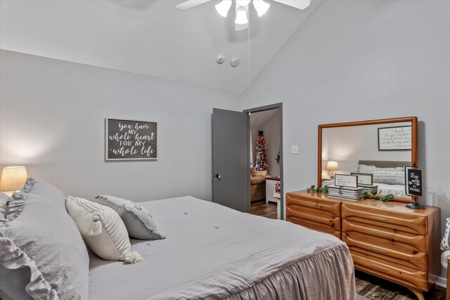 bedroom with ceiling fan, hardwood / wood-style floors, and high vaulted ceiling