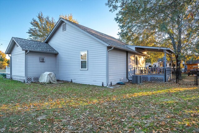 back of house with a lawn, cooling unit, and a wooden deck