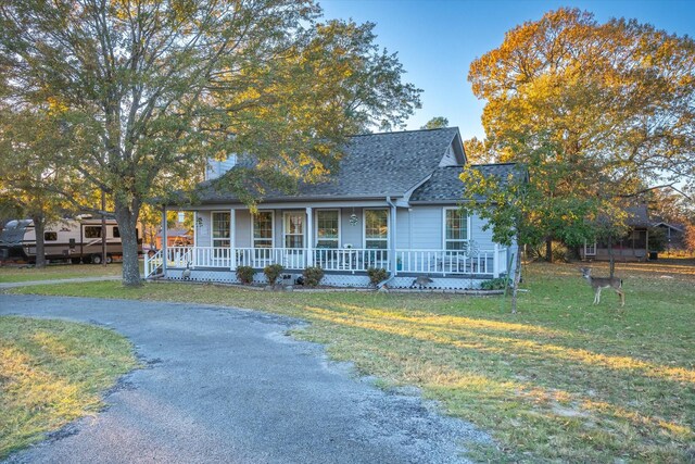 view of front facade with a front yard and covered porch