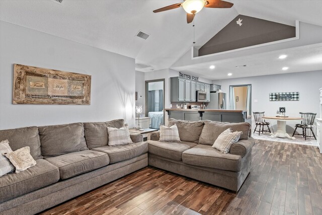 living room featuring ceiling fan, dark hardwood / wood-style flooring, and high vaulted ceiling