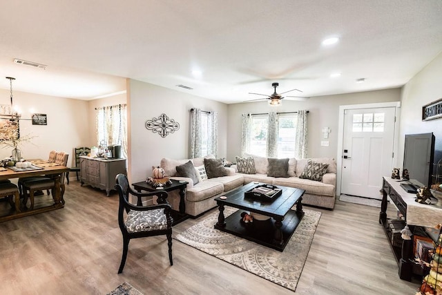 living room with light wood-type flooring and ceiling fan