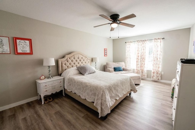 bedroom with ceiling fan and dark hardwood / wood-style flooring