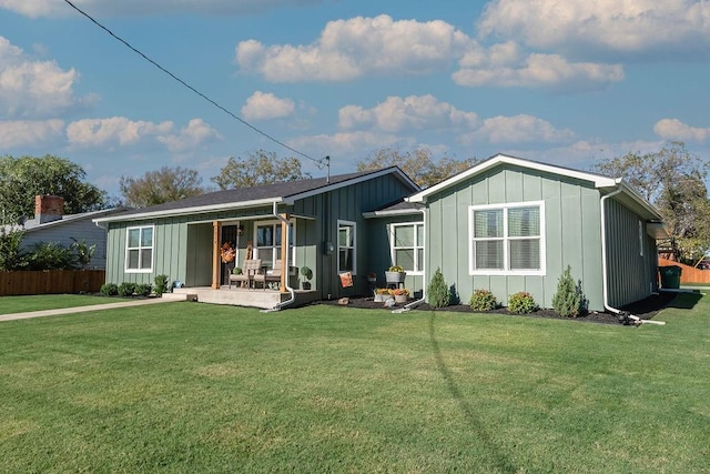 rear view of house featuring a lawn