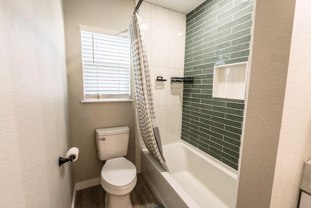 bathroom featuring shower / tub combo, hardwood / wood-style flooring, and toilet