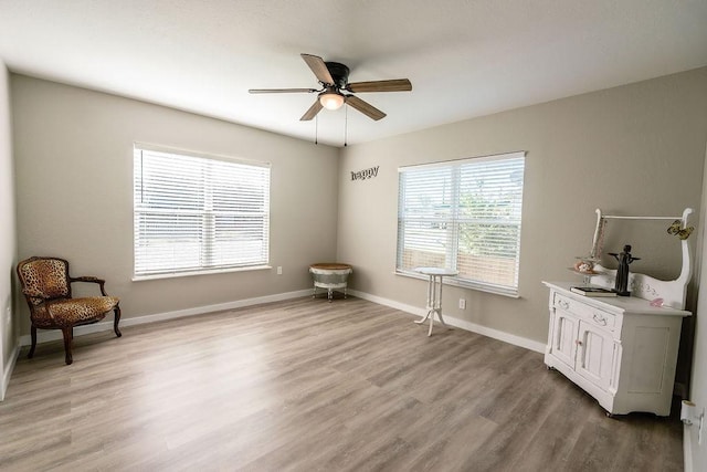 living area featuring ceiling fan and light hardwood / wood-style floors