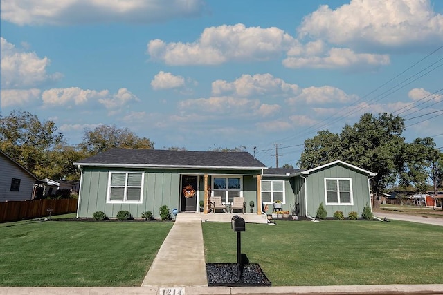 single story home featuring a front lawn and covered porch