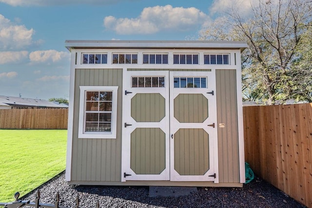 view of outdoor structure featuring a lawn