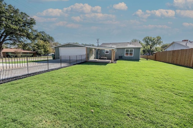 back of house featuring a garage and a yard