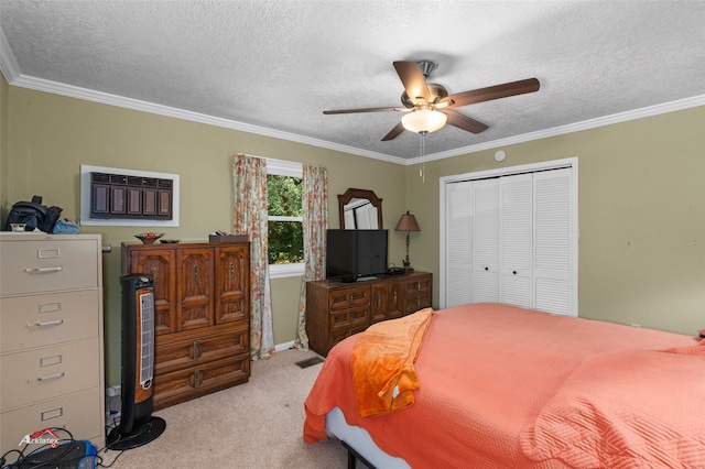 bedroom with ornamental molding, light carpet, a textured ceiling, and a closet