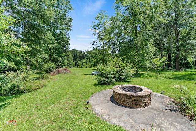 view of yard with a patio and an outdoor fire pit