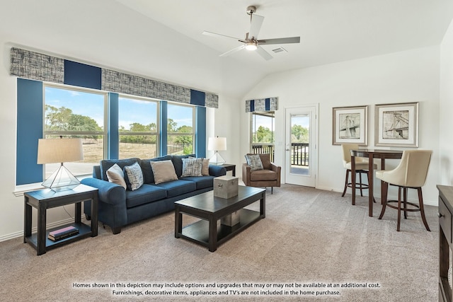 living room featuring ceiling fan, light colored carpet, lofted ceiling, and a wealth of natural light