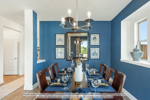 dining room with hardwood / wood-style flooring and an inviting chandelier