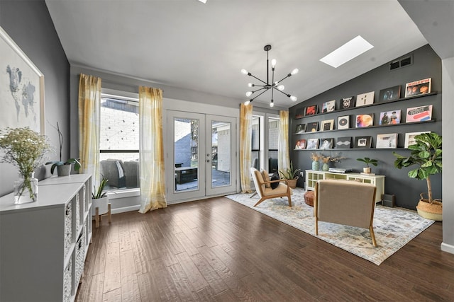 sitting room featuring french doors, lofted ceiling, dark wood-type flooring, and a chandelier