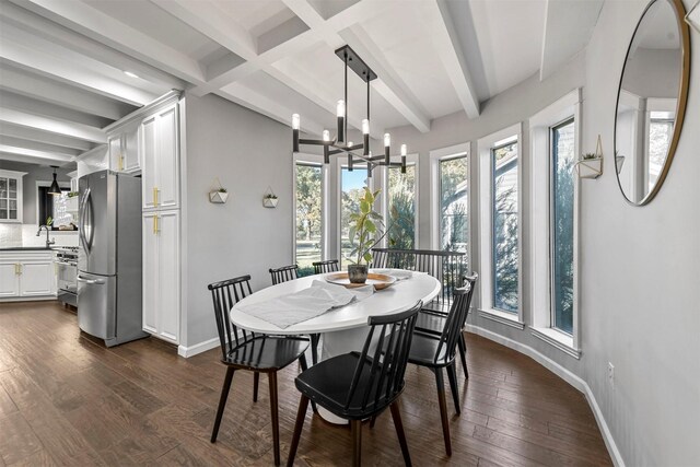 dining area featuring a chandelier, beam ceiling, plenty of natural light, and dark wood-type flooring