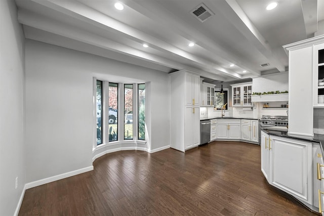 kitchen with white cabinetry, sink, dark wood-type flooring, stainless steel appliances, and tasteful backsplash